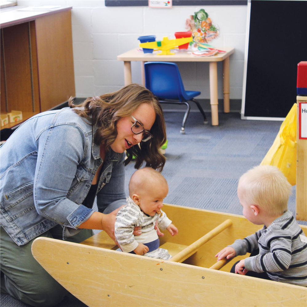  Adult with two children on riding toy